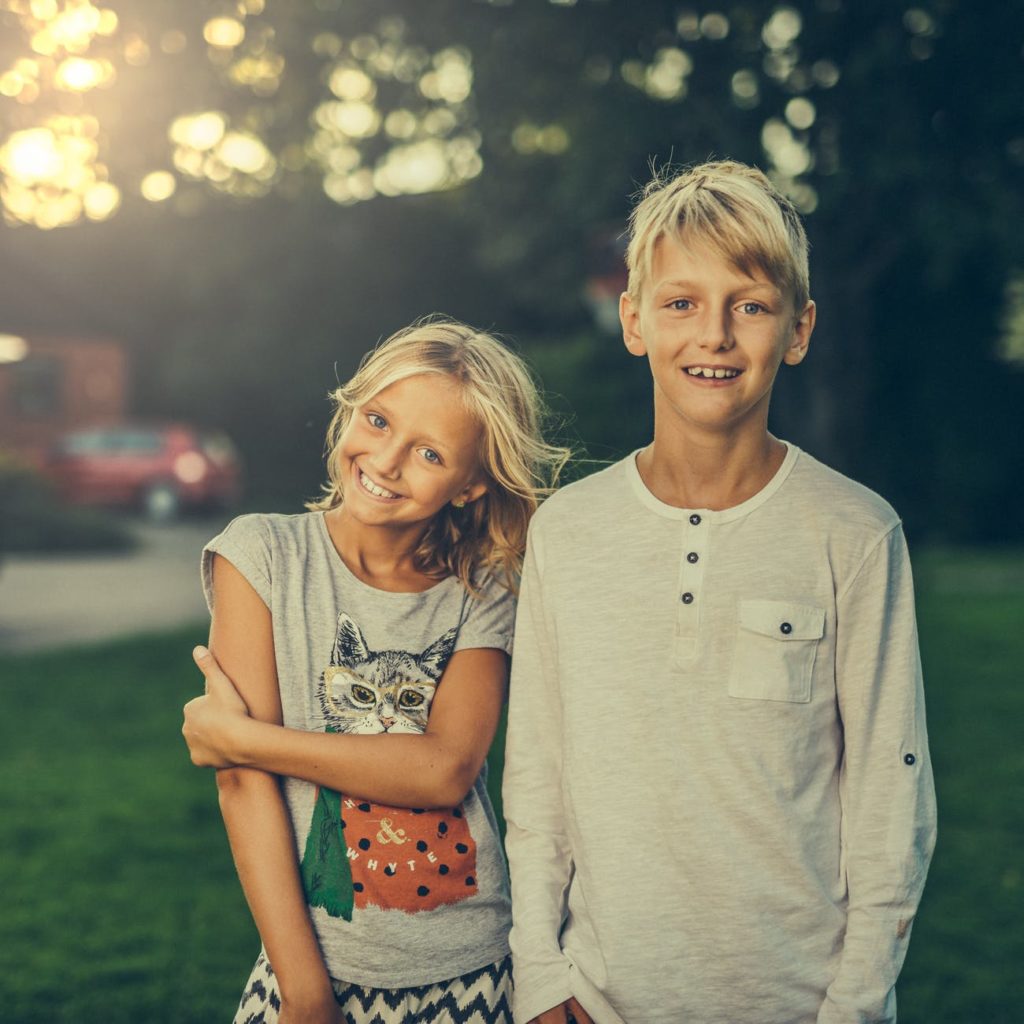 boy standing beside girl outdoors