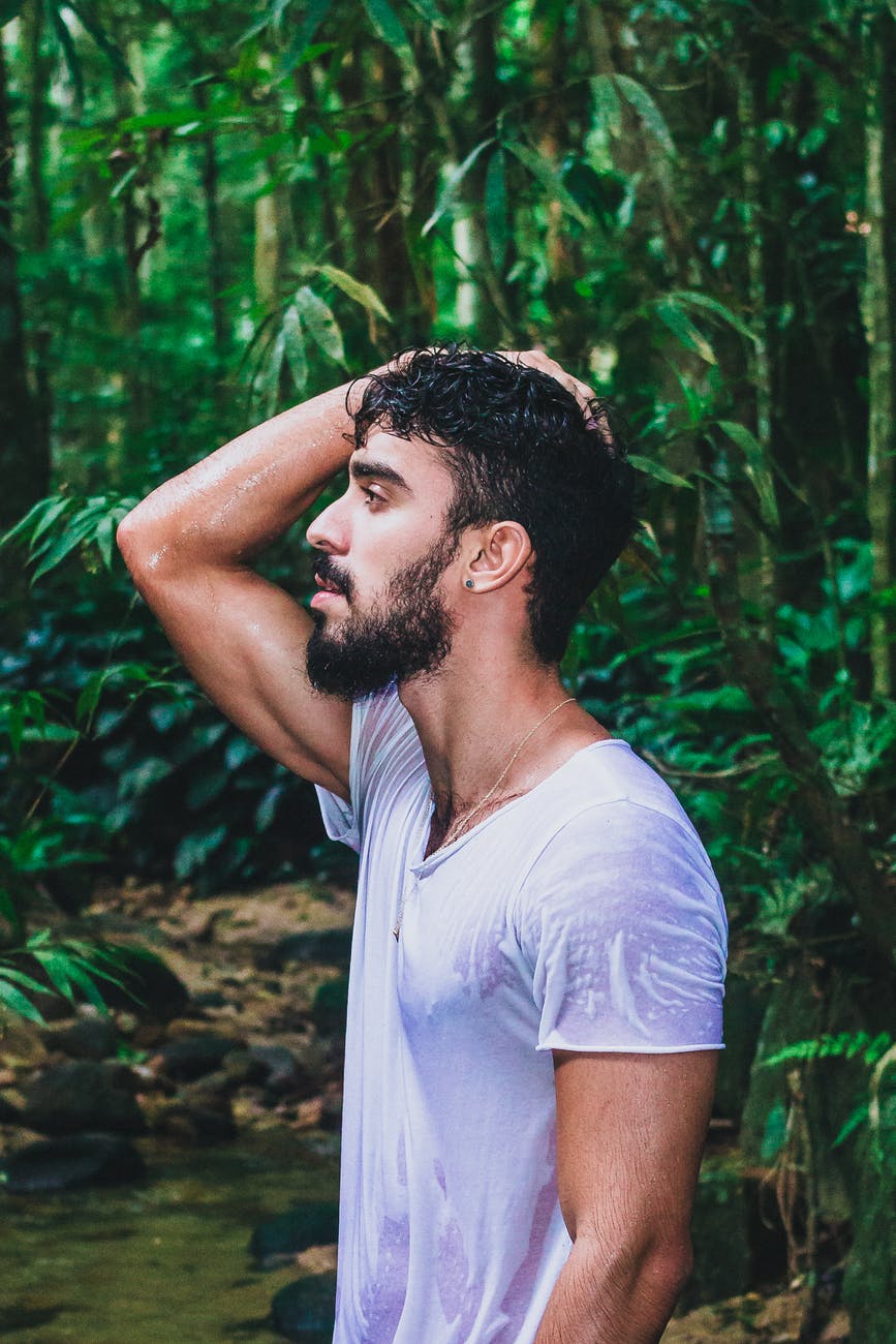 photo of man touching his head