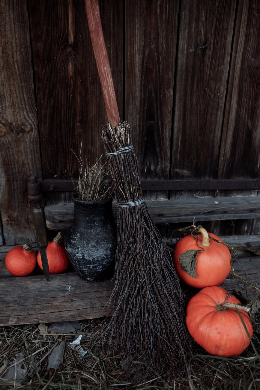 stick broom and small pumpkins