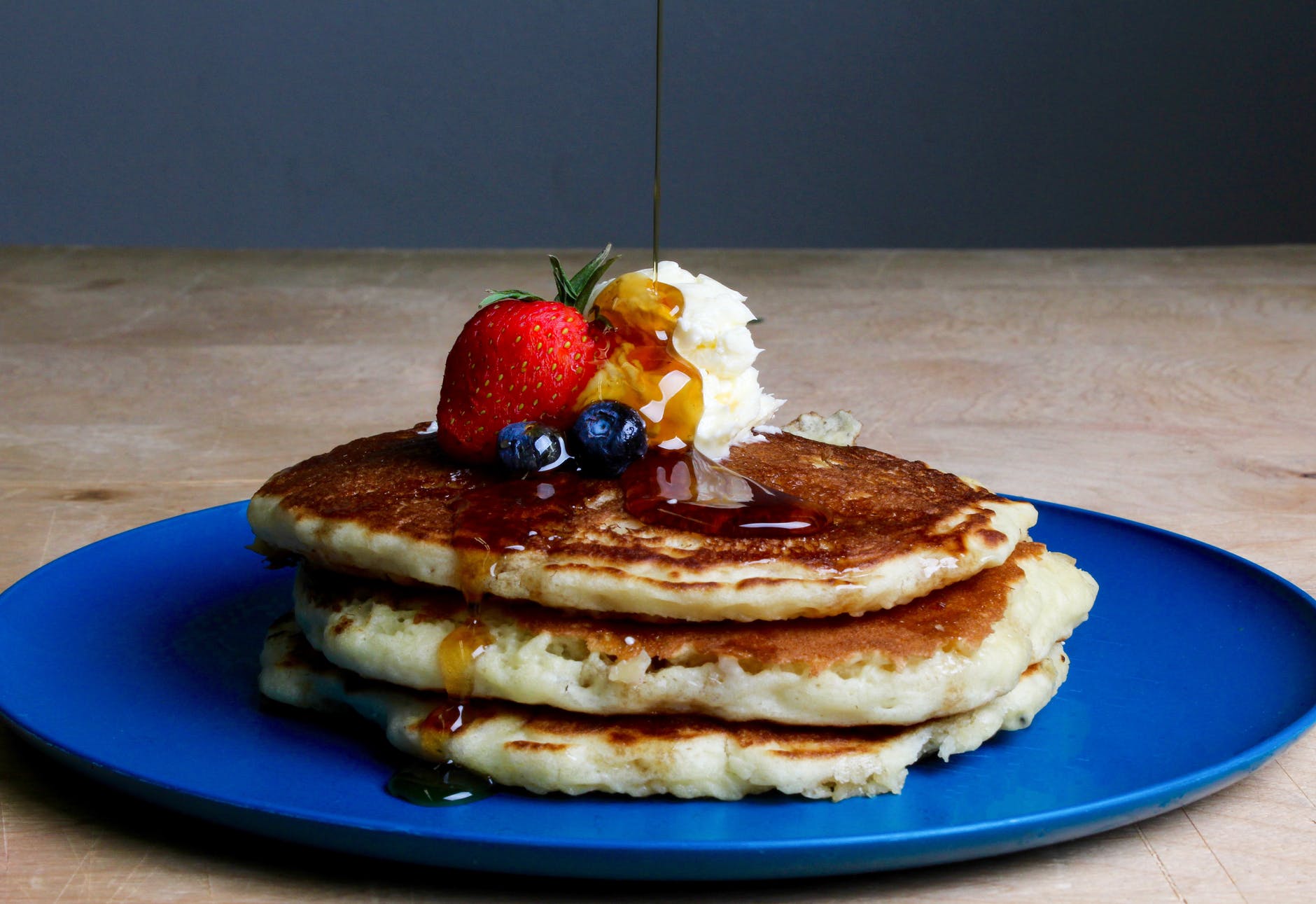 pancakes with strawberry blueberries and maple syrup