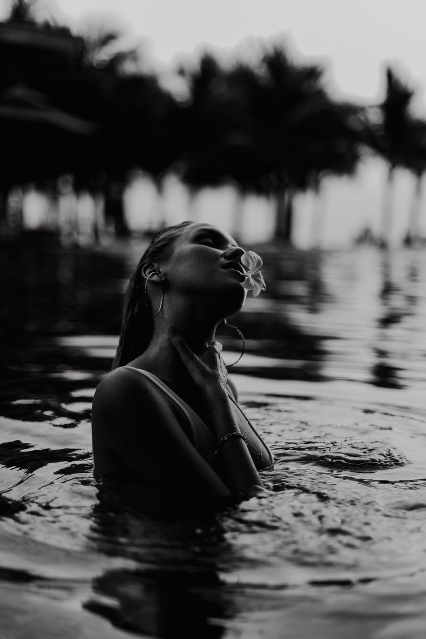 grayscale photo of woman in a pool