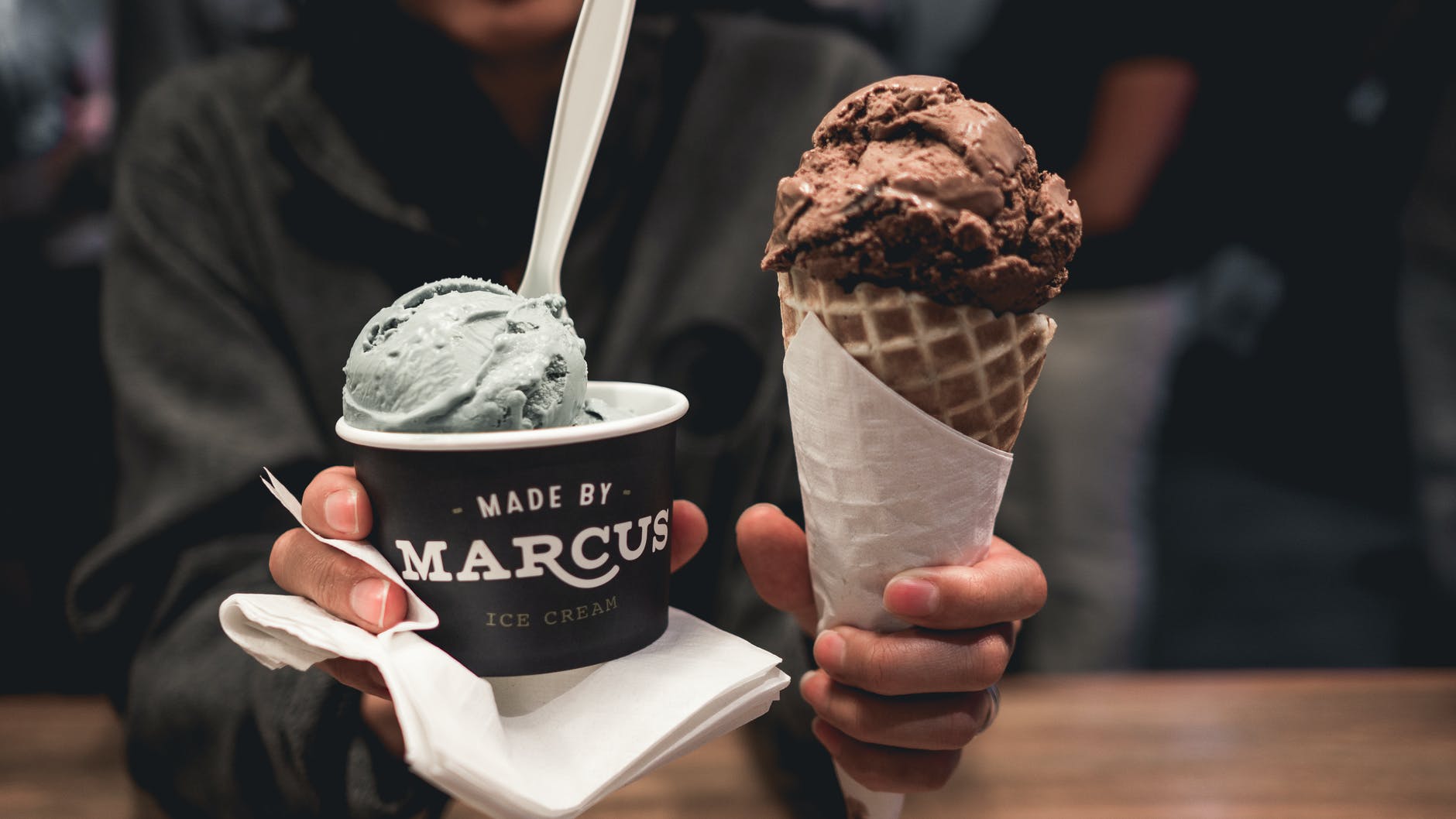 person holding two ice creams