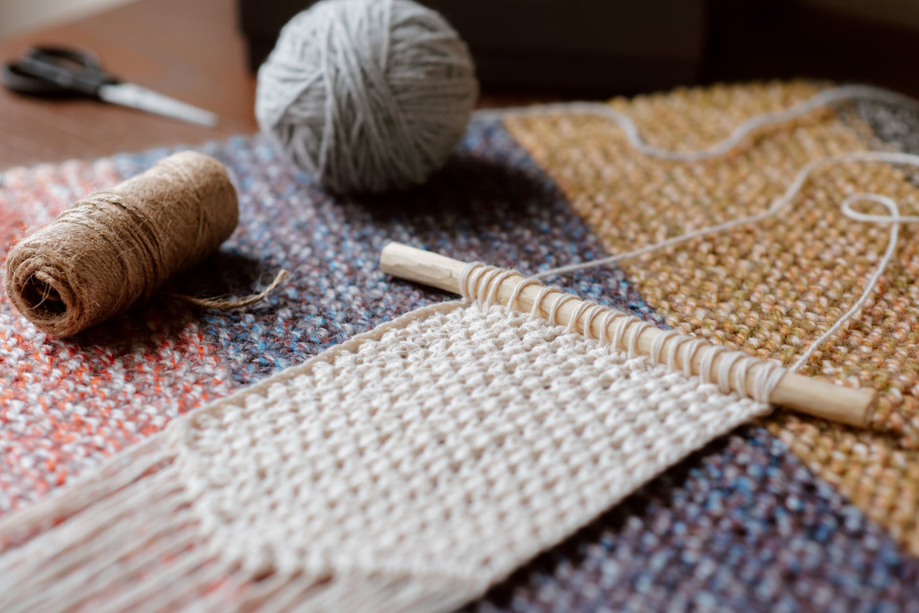 knitted macrame and ball on wool surface