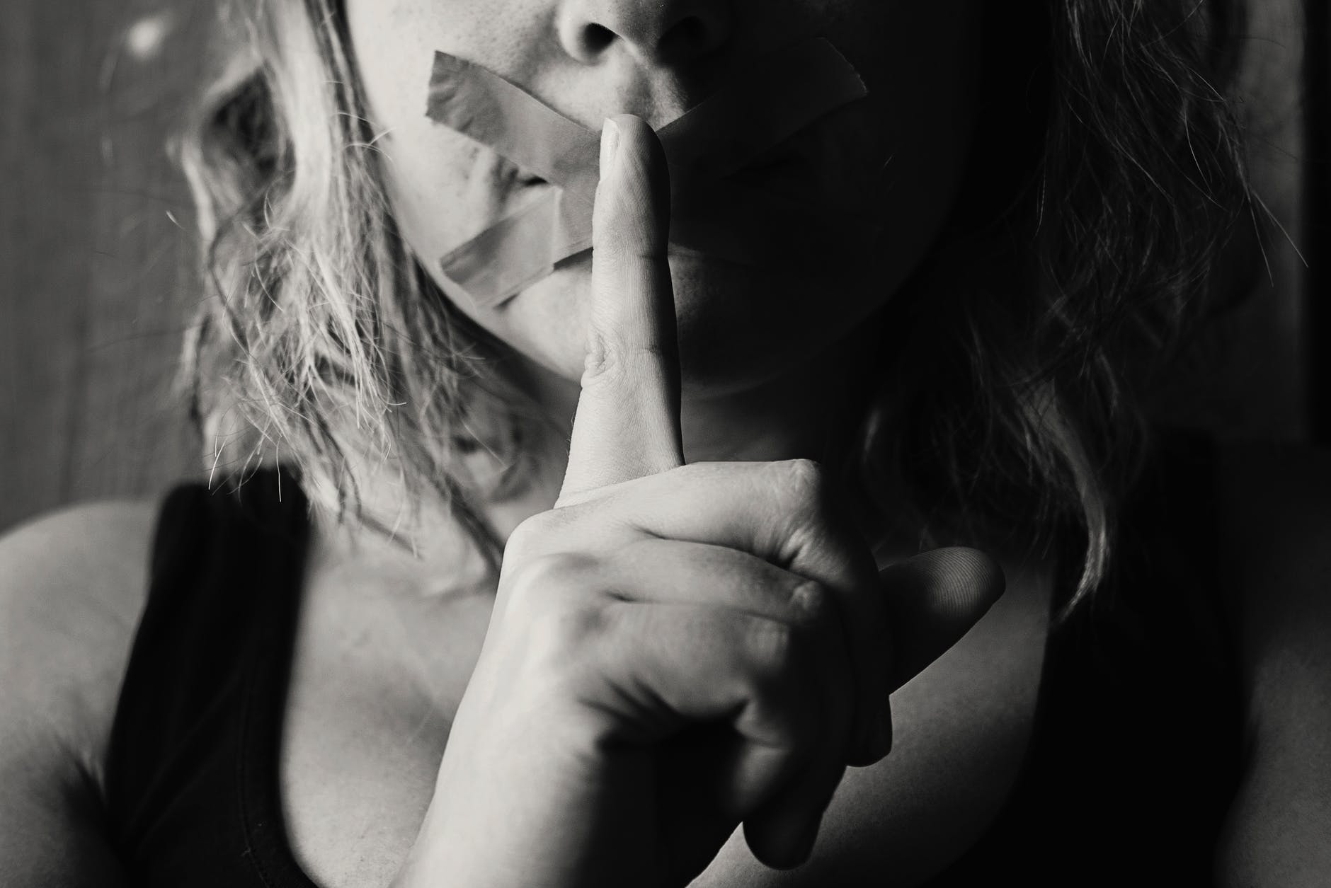 woman placing her finger between her lips