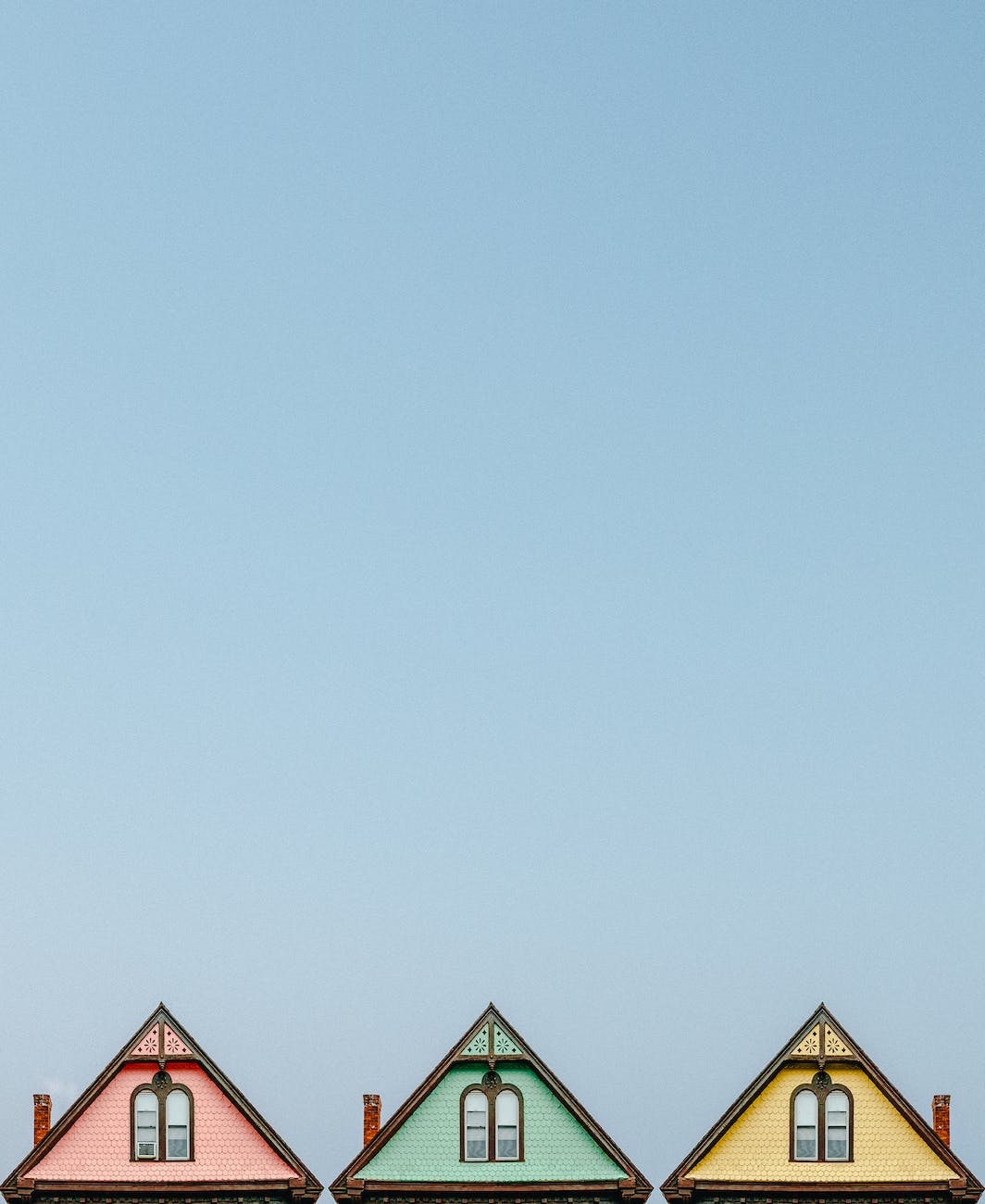 three pink green and yellow houses