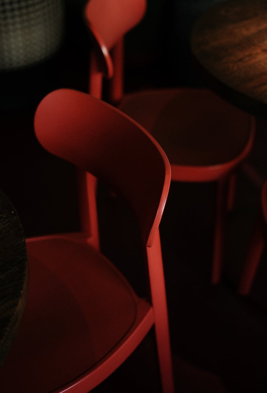 red plastic chair near black textile