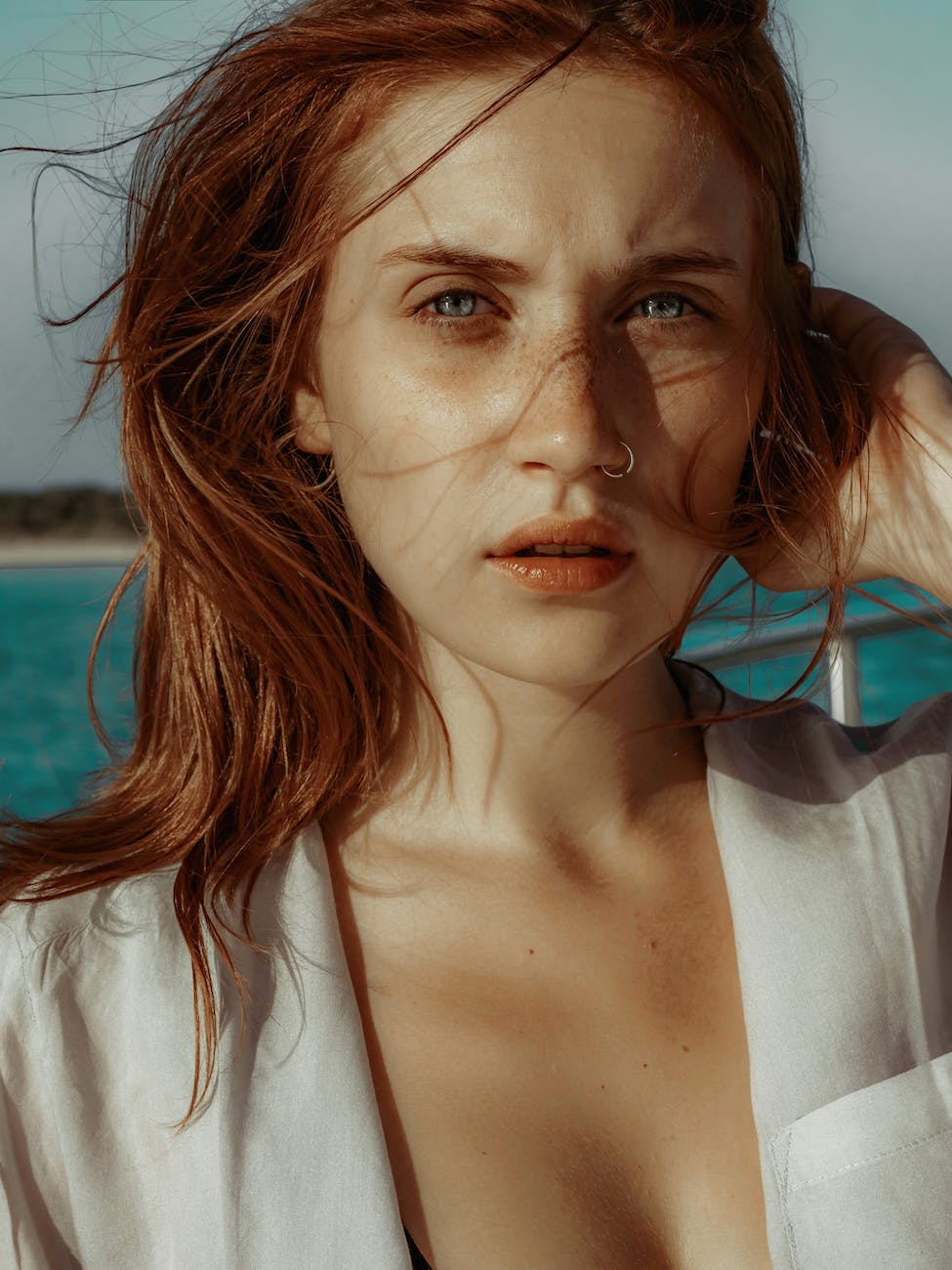 woman with messy hair wearing white top