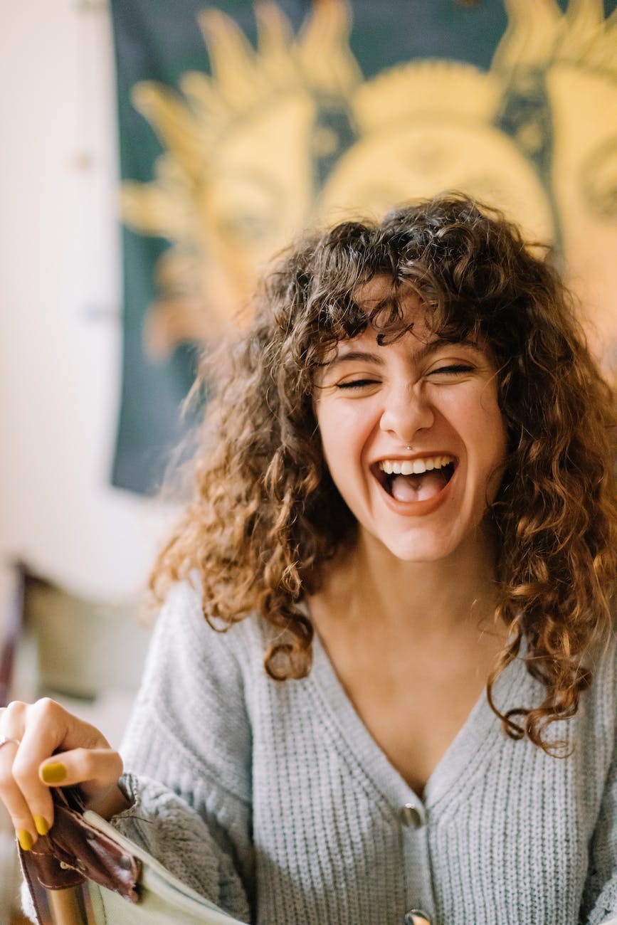 photo of a woman with curly hair laughing