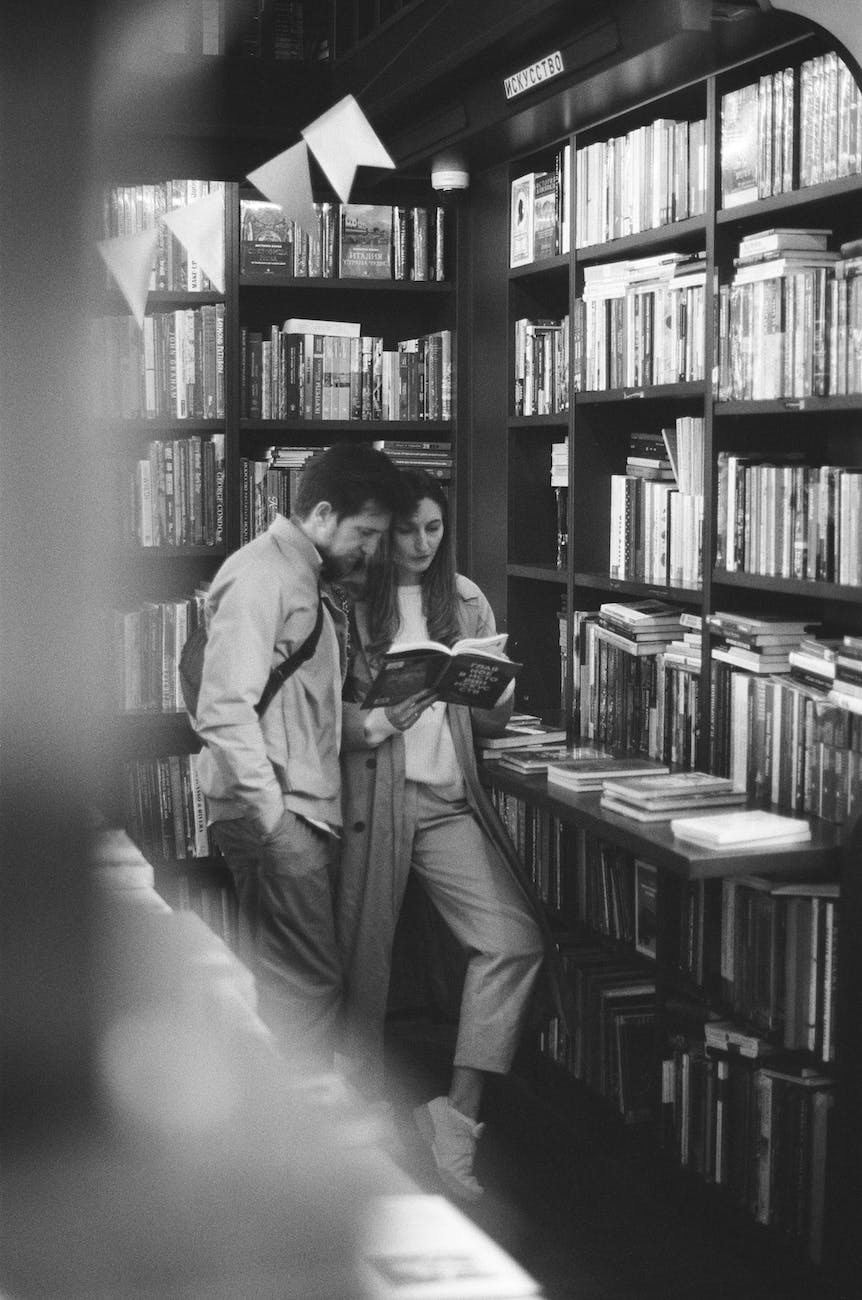 a couple reading a book in the library